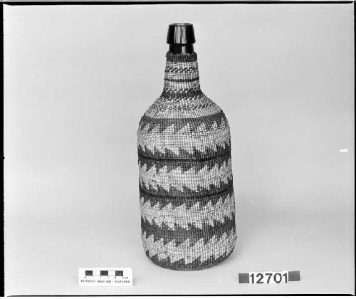 Covered bottle from the collection of the brothers of Mrs. J.M. Robinson, 1883-1925. Twined.