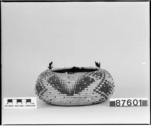 Feathered, beaded, rounded trinket basket. From the collection of Mrs. H.S. Grew. Coiled, three-rod foundation.