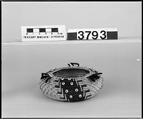 Feathered, beaded, rounded trinket basket. Collected 1897. Coiled, three-rod foundation.