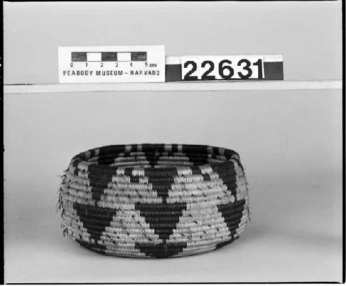 Feathered, low-shouldered trinket basket from the collection of Mrs. S. Cabot. Coiled, three-rod foundation.