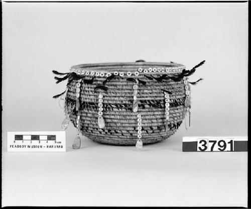 Feathered, beaded, globular trinket basket. Collected 1897. Coiled, three-rod foundation.