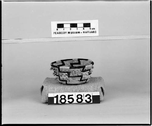 Feathered, flared trinket basket. From the collection of the brothers of Mrs. J.M. Robinson, 1883-1925. Coiled, three-rod foundation.