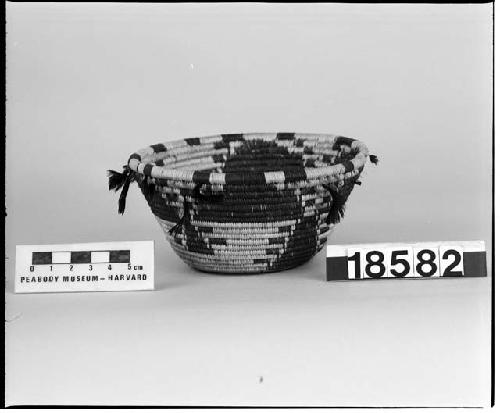 Feathered, flared trinket basket from the collection of the brothers of Mrs. J.M. Robinson, 1883-1925. Coiled, three-rod foundation.