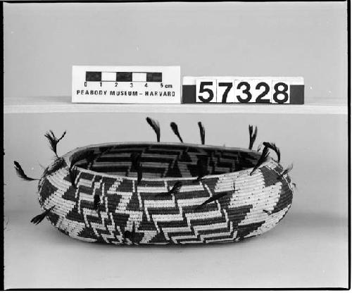 Feathered, oval trinket basket from the collection of Dr. Reynolds. Coiled, three-rod foundation.