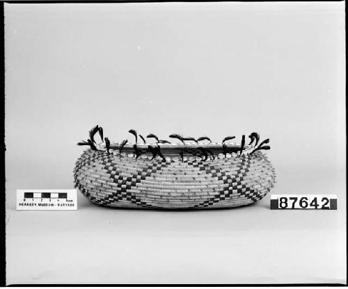 Feathered, beaded oval trinket basket. From the collection of Mrs. H.S. Grew. Coiled, three-rod foundation.