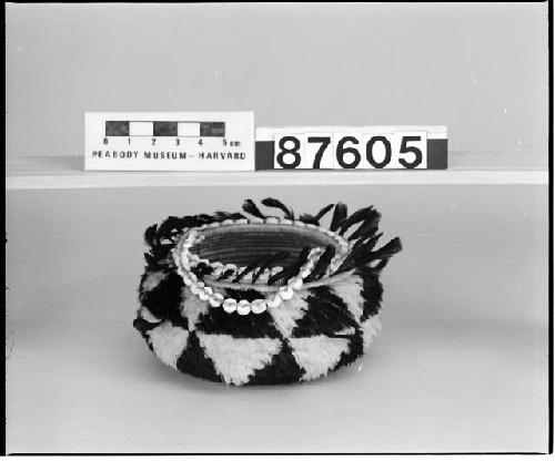 Feathered and beaded basket from the collection of Mrs. H.S. Grew. Coiled, three-rod foundation.