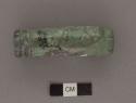 Fragment of tubular jade bead with decorated end; 21mm diam.