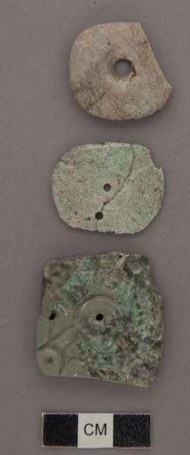 2 broken disc-like decorated jade buttons - 27x28x4 mm.; 24x30x2 mm.