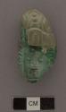 Portion of carved jadeite ornament, human face