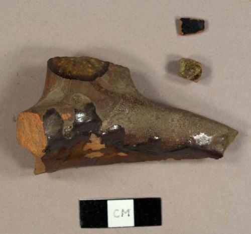 Lead glazed refined redware sherds, one is a handle and rim sherd to a possible pot