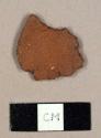 Unglazed, coarse redware sherd, possibly originally disk-shaped