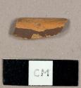 Unglazed refined redware sherd with brown slip on exterior