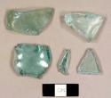 Aqua bottle glass fragments, including one possibly melted fragment