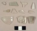 Colorless curved glass fragments, including one molded fragment and one possibly from a hurricane lamp