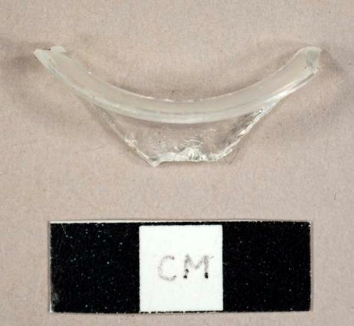 Colorless curved glass fragment, possibly from a hurricane lamp