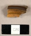Brown glazed stoneware sherd, possibly a lid