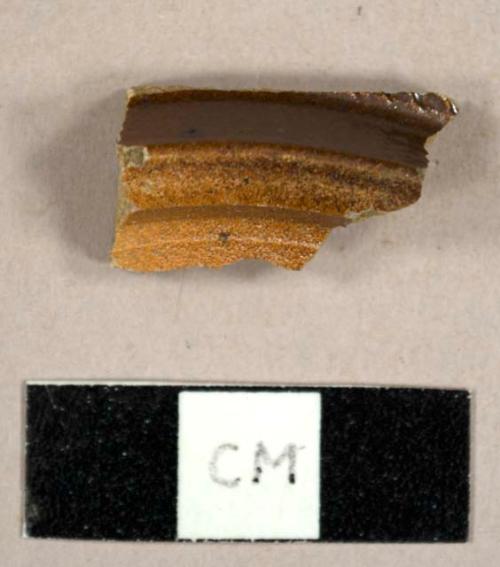 Brown glazed stoneware sherd, possibly a lid