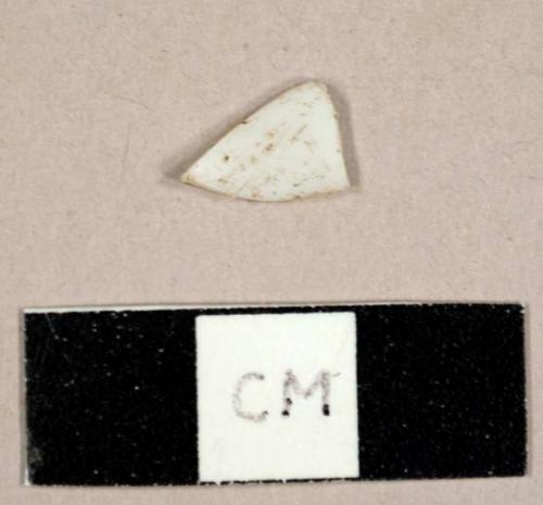 Curved white plastic fragment, possibly from a spoon