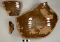 Refined redware bowl sherds with lead glaze on interior, including one rim sherd