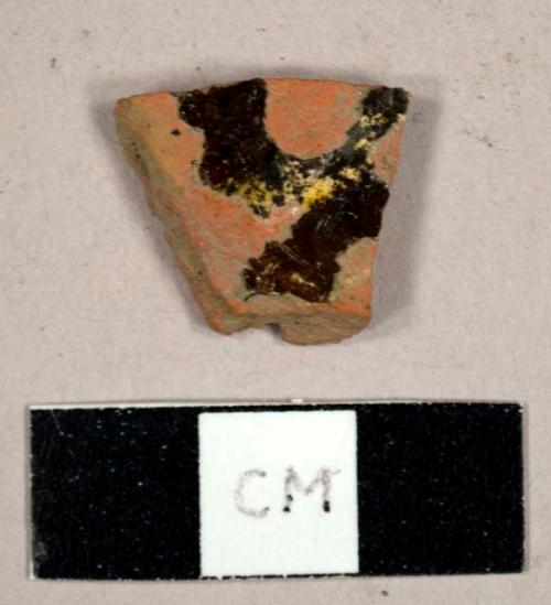 Refined redware sherd wtih slip decoration and lead glaze