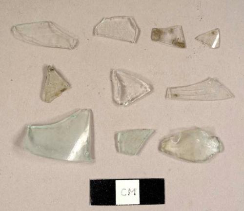 Colorless curved glass fragments, including some possible fragments from a hurricane lamp