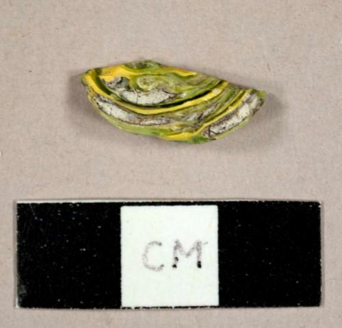 Green and yellow glass fragment with possible ceramic inclusions