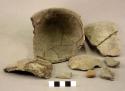 Ceramic rim and body sherds, notched rim, shell temper, mended, 1 pebble