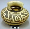 Fine geometric black-on-yellow pottery small jar