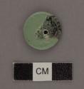 Fragment of small carved jade disc. About 20 mm diam. x 2 mm