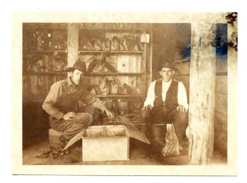 Two men packing skeletons at Pecos. Christino Varela, left.