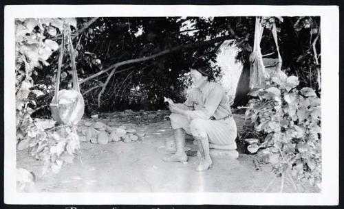 Scan of page from Judge Burt Cosgrove photo album.  Posing for a picture.