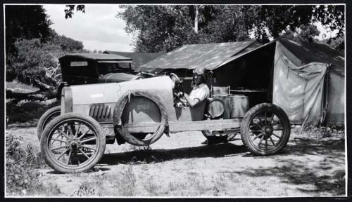 Scan of page from Judge Burt Cosgrove photo album.  Automobile at Swarts camp.