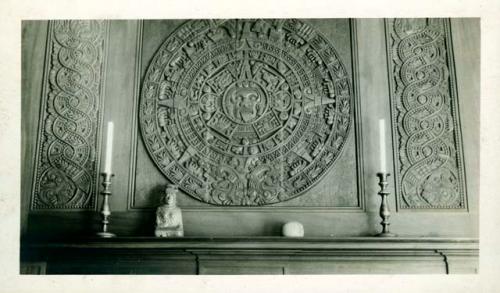 Scan of photograph from Judge Burt Cosgrove photo album.Wood carving of Aztec Calendar Stone A.M.Tozzer residence.