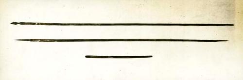 Scan of photograph from Judge Burt Cosgrove photo album.Atlatl or spear thrower and darts. Darts from Ceremonial Cave N.E of El Paso Tex. Atlatl from Chavez Cave near Las Cruces New Mexico.