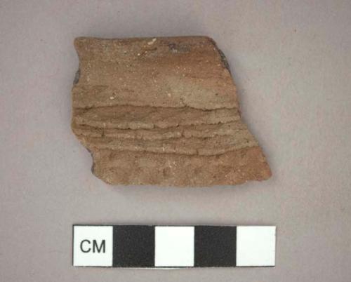 Ceramic rim sherd, corrugated