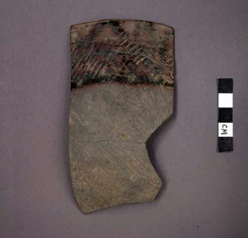 Ceramic rim sherd of bowl, painted and incised designs, mended