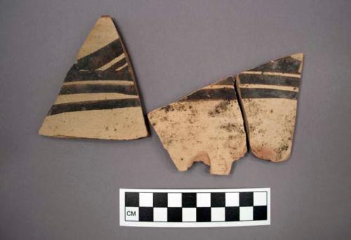 Ceramic body and rim sherds of bowl, black painted designs both sides