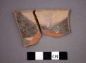 Ceramic rim sherds of bowl, black painted design interior, will mend together