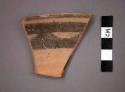 Ceramic rim sherd of bowl, black painted designs at interior