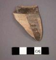 Ceramic rim sherd with black painted designs on exterior