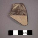 Ceramic rim sherd with black painted designs on exterior