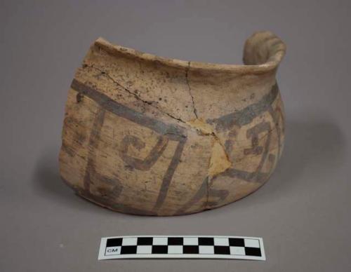 Fragments of black on yellow pottery jar