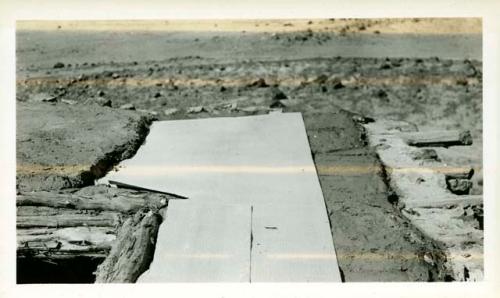 Scan of page from Judge Burt Cosgrove photo album.Rebuilding roof of Room 7 Felt and last coat of adobe