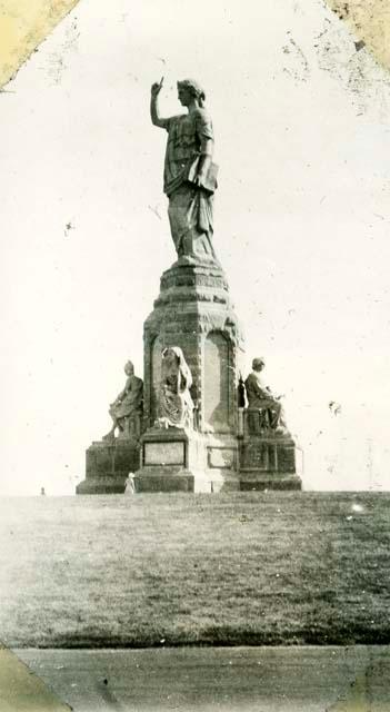 Scan of page from Judge Burt Cosgrove photo album.Monument at Plymouth Mass.