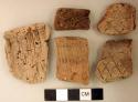 Coarse earthenware rim sherds, some incised, some cord impressed