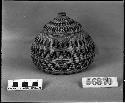 Lidded trinket basket, collected by unknown. Coiled, three-rod foundation.