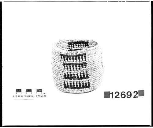 Small cylindrical basket from the collection of the brothers of Mrs. J.M. Robinson, 1883-1925. Coiled.