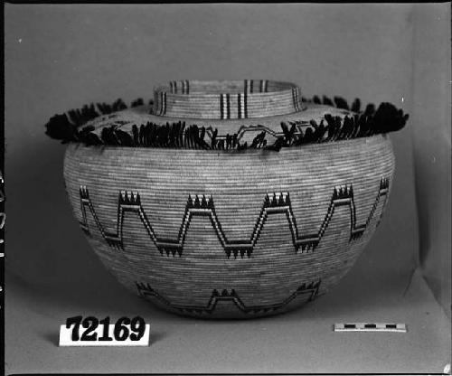 Bottleneck basket with feather decoration, from the collection of G. Nicholson. Coiled, bundle foundation(?).