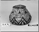 Lidded jar (lid missing) from the collection of W. Ellery. Coiled, three-rod foundation, non-interlocking stitches.