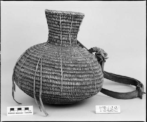 Water bottle, from the collection of G. Nicholson and C. Hartman. Coiled, three-rod foundation, non-interlocking stitches.